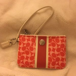 Small pink and white coach wristlet